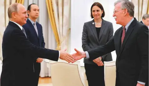  ?? AP ?? Russian President Vladimir Putin greets US National Security Adviser John Bolton during their meeting in the Kremlin in Moscow, Russia, yesterday.