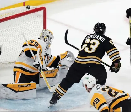  ?? MICHAEL DWYER — THE ASSOCIATED PRESS ?? Boston Bruins’ Brad Marchand (63) scores on Pittsburgh Penguins’ Alex Nedeljkovi­c (39) during the second period of an NHL hockey game, Saturday, March 9, 2024, in Boston.