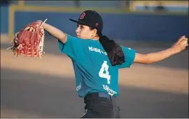  ??  ?? JOSELYN HERNANDEZ, 12, warms up before Municipal de Tijuana’s practice. The team had been among the favorites to go to the Little League World Series.