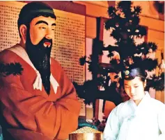  ??  ?? An attendant prepares offerings at a shrine to Dangun, the mythical founder of the first unified Korean kingdom in 2333 BCE, during a Foundation Day ceremony in Seoul, South Korea. — Reuters photo