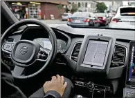  ?? AP/ERIC RISBERG ?? An Uber driverless car waits in traffic during a test drive in San Francisco in late 2016.