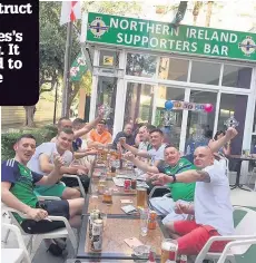  ??  ?? HIGH SPIRITS Supporters enjoy a drink outside the fans’ pub