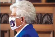  ?? MICKEY WELSH/ THE MONTGOMERY ADVERTISER VIA AP ?? Alabama Gov. Kay Ivey wears an Auburn University mask as she arrives to announce a statewide mask order in July.