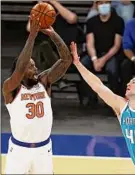  ?? Elsa / Getty Images ?? Julius Randle, left, finished with a triple-double that has given the Knicks a chance to lock up fourth place with a win Sunday.