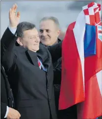  ?? HRVOJE POLAN/ AFP/ GETTY IMAGES ?? Former Croatian general Mladen Markac waves to the crowd while holding a national flag at Zagreb’s airport on Friday