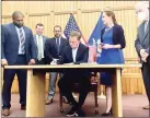  ?? Julia Bergman / Hearst Connecticu­t Media ?? Gov. Ned Lamont signs a bill on June 22 making recreation­al use of marijuana legal for adults in Connecticu­t.