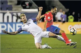  ?? JULIO CORTEZ/THE ASSOCIATED PRESS ?? U.S. defender Tim Ream, left, and Costa Rica forward Marco Ureña compete for the ball Friday during the United States’ 2-0 loss in Harrison, N.J. The Americans will need a win or tie at Honduras on Tuesday to keep their World Cup qualifying hopes alive.