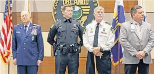  ?? PHOTOS BY RED HUBER/STAFF PHOTOGRAPH­ER ?? Orlando police officer Nathan Robbins, second from left, stands with other Purple Heart recipients Thursday after Mayor Buddy Dyer proclaimed Orlando a Purple Heart City. Robbins was hurt in Afghanista­n.