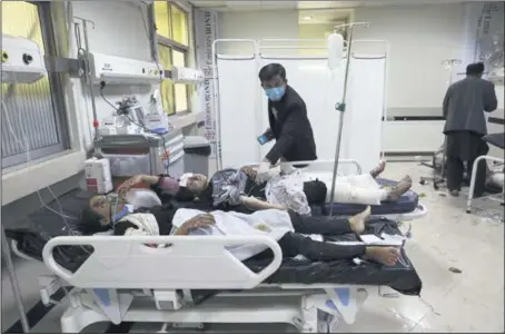  ?? RAHMAT GUL — THE ASSOCIATED PRESS ?? Wounded school students are treated at a hospital after a bomb explosion near a school in west Kabul, Afghanista­n, on Saturday. Most of the killed were young pupils.