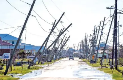  ?? BILL FEIG/ THE ADVOCATE VIA AP ?? Power poles lean or are broken after Hurricane Zeta on Thursday in Grand Isle, La.