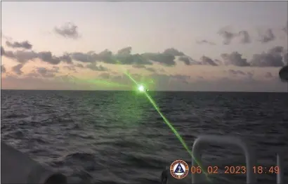  ?? PHILIPPINE COAST GUARD VIA AP ?? This photo provided by the Philippine Coast Guard shows a green military-grade laser light from a Chinese coast guard ship in the disputed South China Sea, Monday, Feb. 6, 2023.