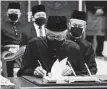  ?? Associated Press ?? Prime Minister Ismail Sabri Yaakob signs documents after taking the oath as Malaysia’s new leader.