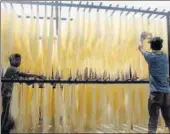  ?? PTI PHOTO ?? Workers dry vermicelli, used to make a traditiona­l sweet dish, ahead of Eid ulFitr in Allahabad on Sunday.