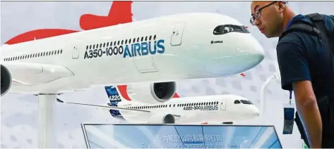  ?? — AFP ?? Looking good: A visitor admiring an Airbus A350-1000 plane model at the Beijing Internatio­nal Aviation Expo. The world’s fleet of passenger jets and freighters will more than double to 47,680 aircraft by 2038.