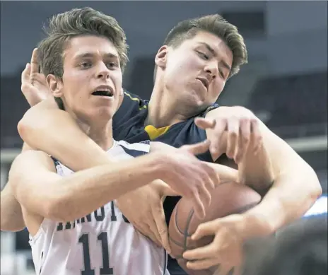  ?? Steph Chambers/Post-Gazette photos ?? Abington Heights’ Corey Perkins, left, and Mars’ Raymond Kahn battle for a rebound Tuesday in the Class 5A final.