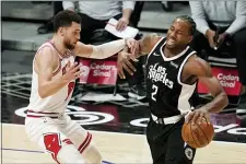  ?? THE ASSOCIATED PRESS ?? Clippers forward Kawhi Leonard, right, is fouled by Bulls guard Zach LaVine Sunday in Los Angeles.