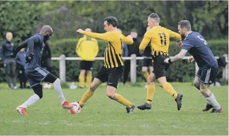  ?? ?? P enshaw Catholic Club Over-40s (yellow) in action against Blyth Mason Arms, played at New Herrington Welfare Ground.