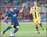  ??  ?? HITMAN: Mkhitaryan against old club Dortmund