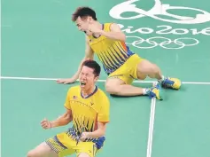  ??  ?? Goh V Shem (left) and Tan Wee Kiong of Malaysia celebrates after winning their men’s doubles semi-final against Chai Biao and Hong Wei of China at the Riocentro, Pavilion 4 in Rio de Janeiro last night.The national duo won 21-18, 12-21, 21-17.The gold...