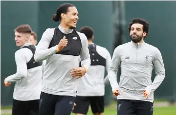  ??  ?? Liverpool’s Virgil van Dijk (left) and Mohamed Salah attend a training session at the team’s Melwood training complex in Liverpool, north west England. — AFP photo