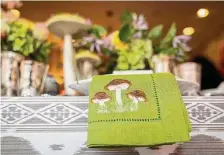  ?? ?? Mushroom linen napkins echo the theme of the Woodland Moss Decoration Set used on the table.