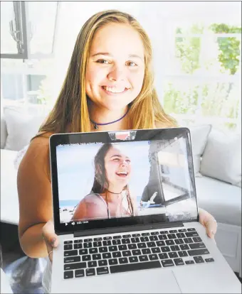  ?? Bob Luckey Jr. / Hearst Connecticu­t Media ?? Greenwich High School senior Lucy Massam, 17, with her computer featuring a video of herself at her home in Greenwich on May 24. Massam has been busy with a YouTube vlog and with offering her expertise in helping other students cope with stress and pressure.