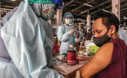  ?? Adam Dean / New York Times ?? A man gets a COVID-19 vaccine in Bangkok. Countries struggling to obtain vaccines may be able to make NDV-HXP-S for themselves or buy it at low cost.