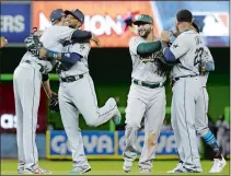  ?? LYNNE SLADKY/ AP PHOTO ?? Robinson Cano of the Seattle Mariners, second from left, is greeted by Cleveland Indians pitcher Andrew Miller after the American League won Tuesday’s All-Star Game 2-1 over the National League. Cano hit the gamewinnin­g home run in the 10th.