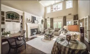  ?? SUBMITTED PHOTOS ?? A coffered ceiling and a gas-log fireplace flanked by built-in shelves add appeal to the living room.