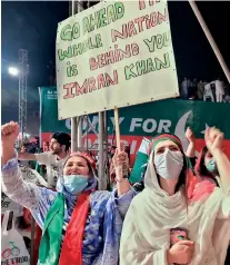  ?? ?? Supporters of the Pakistan Tehreek-e-Insaf (PTI) political party carry placards in support of former Pakistani PM Imran Khan, in Peshawar, Pakistan. (Reuters)