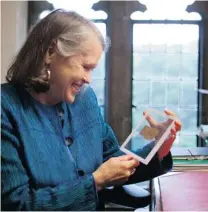  ?? PHOTOS: THE ASSOCIATED PRESS FILES ?? Harvard professor Karen King holds a papyrus that new scientific tests suggest is more likely an ancient document than a forgery.