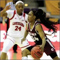  ?? (Photo courtesy UALR Athletics) ?? UALR’s Mayra Caicedo (right) drives around Louisiana-Lafayette’s Jomyra Mathis during Sunday’s Sun Belt Conference Tournament semifinal in Pensacola, Fla. Caicedo had 11 points and six assists for the Trojans, who lost 58-48.