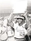  ?? AP FILE ?? Lou Brock celebrates with his Cardinals teammates after breaking Ty Cobb’s all-time stolen bases record during a game in 1977. Brock, like Aaron, died in the last year.