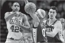  ?? MICHAEL DWYER/AP PHOTO ?? Al Horford of the Celtics (42) passes off in front of Jerryd Bayless of the 76ers (0) during the second quarter of Thursday’s game.