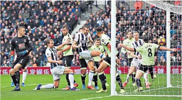  ??  ?? Set-piece success: Gareth McAuley smashes the ball home from close range after a mistake by Artur Boruc at a corner