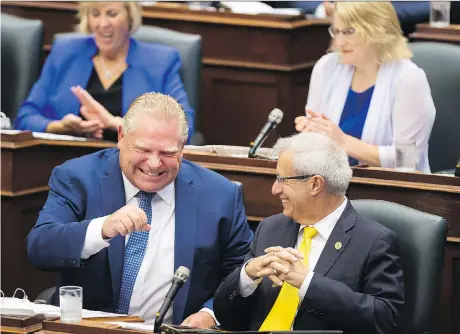  ?? NATHAN DENETTE /THE CANADIAN PRESS ?? Ontario Premier Doug Ford was in a laughing mood with Finance Minister Vic Fedeli during question period at Queen’s Park Monday in Toronto as debate continued over the government’s contentiou­s Bill 31, which will hack Toronto council seats from 47 to 25.