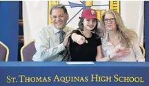  ?? MICHAEL LAUGHLIN/STAFF PHOTOGRAPH­ER ?? Allana Quiton, with parents Al and Jeannette, announces she’s opted to attend FSU during last week’s signing day at St. Thomas Aquinas.