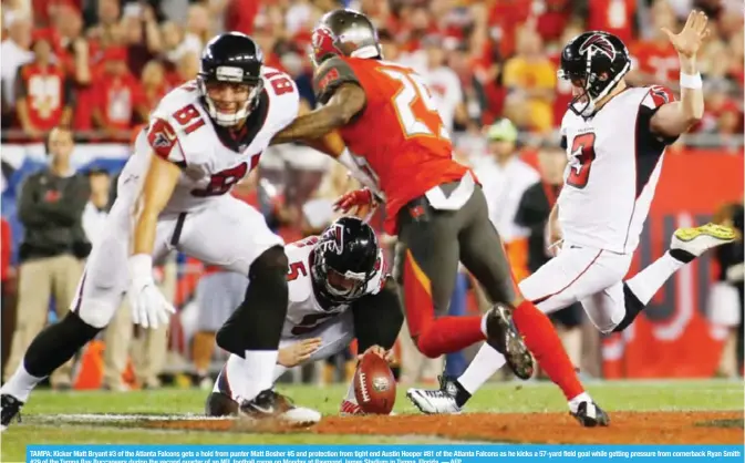  ??  ?? TAMPA: Kicker Matt Bryant #3 of the Atlanta Falcons gets a hold from punter Matt Bosher #5 and protection from tight end Austin Hooper #81 of the Atlanta Falcons as he kicks a 57-yard field goal while getting pressure from cornerback Ryan Smith #29 of...
