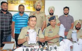  ?? HT PHOTO ?? Police with the seized contraband in Amritsar on Tuesday.