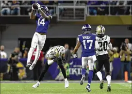  ?? HANNAH FOSLIEN / GETTY IMAGES ?? Vikings receiver Stefon Diggs leaps in front of Saints rookie safety Marcus Williams to catch a pass from Case Keenum on the winning play.