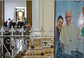  ?? INTI OCON / AP, FILE ?? A poster featuring Bishop Rolando Alvarez and Pope Francis hangs inside the Cathedral in Matagalpa, Nicaragua on Aug. 19, 2022.