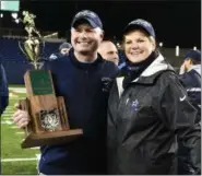  ?? NEWS-HERALD FILE ?? Kenston coach Jeff Grubich and school superinten­dent Nancy Santilli enjoy the Division III state championsh­ip trophy Nov. 30.