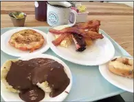  ?? Arkansas Democrat-Gazette/ERIC E. HARRISON ?? Weekend brunch at Cathead’s Diner included (clockwise from top left) doughnut French toast; smoked rib, bacon and cheesy rice grits; a maple bacon doughnut with bacon in the icing; and a cathead biscuit topped with chocolate gravy.