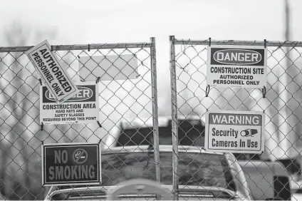  ?? Mark Felix / Bloomberg file photo ?? Signs warn people outside a Tesla subsidiary registered as Gambit Energy Storage LLC, which is building a power storage project near Angleton for more than 100 megawatts of energy. The town is about 40 miles south of Houston. While its applicatio­n to the PUC did not include many specifics, a new Tesla subsidiary, Texas Energy Ventures, says it has about $1 million in assets as of mid-August and that it aims to sell renewable energy credits.