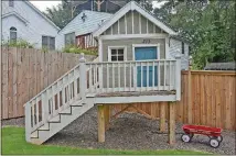  ??  ?? Seven and 9-year-old Jane and Avery Breslin have their own “doll house” in their backyard. The playhouse was already on the lot when their parents, Kate and Dave Breslin, bought the land from their neighbors, who originally built the playhouse for...