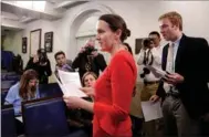  ?? REUTERS JOSHUA ROBERTS / ?? Deputy White House Press Secretary Lindsay Walters hands out a statement relating to the firing of FBI Director James Comey by US President Donald Trump at the White House in Washington on Tuesday.