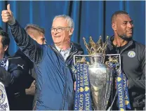  ??  ?? Claudio Ranieri with the Premier League trophy and his Leicester captain, Wes Morgan.