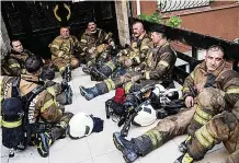  ?? ?? HARD WORK Firefighte­rs rest after rescue efforts yesterday