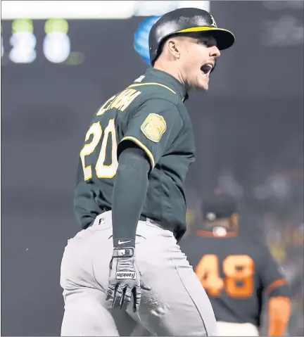  ?? MARCIO JOSE SANCHEZ — THE ASSOCIATED PRESS ?? A’s Mark Canha celebrates as he rounds the bases on a two-run home run against the Giants in the seventh inning Saturday night.