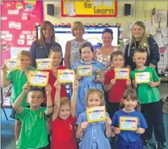  ??  ?? Children from local schools helped raise money by packing shopping bags for two local charities